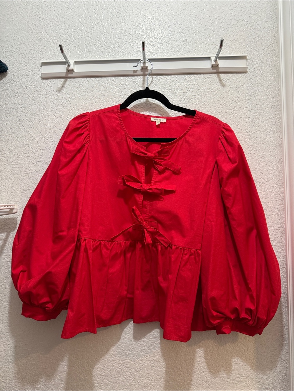 JODIFL Red Bow-Tie Peplum Blouse with Puff Sleeves